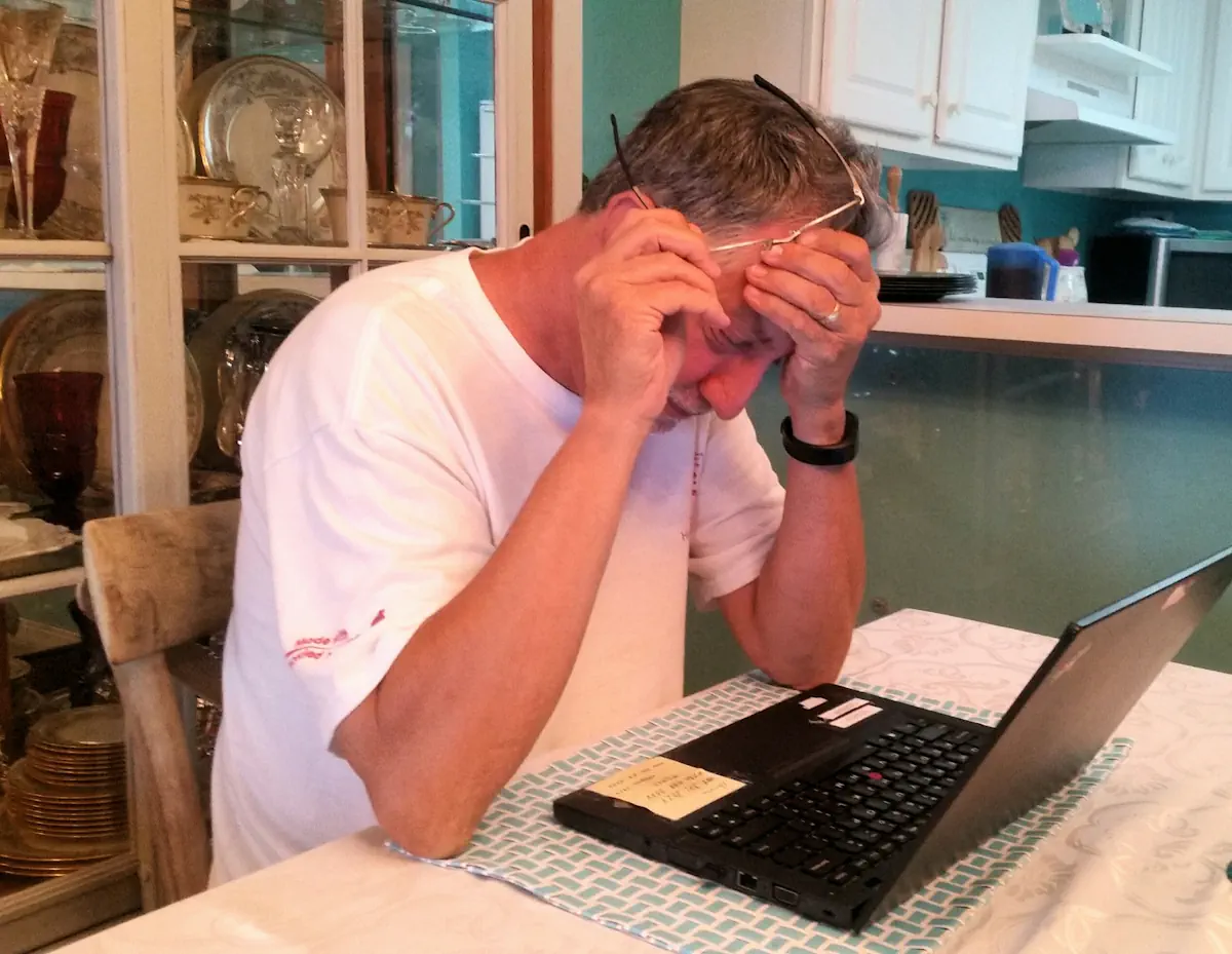 Un homme triste devant un ordinateur